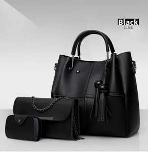 Detailed view of black 3-in-1 handbag set featuring pebble texture and tassel charm