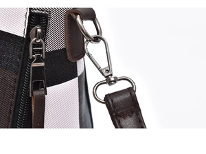 Close-up of classic check pattern canvas bag with silver hardware and brown leather trim