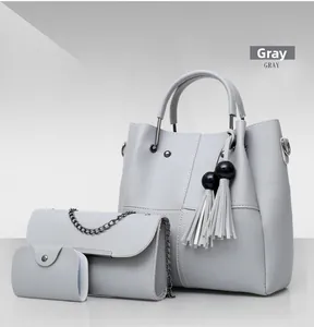 Detailed view of gray 3-piece bag set with tassel tote, chain crossbody and small wallet