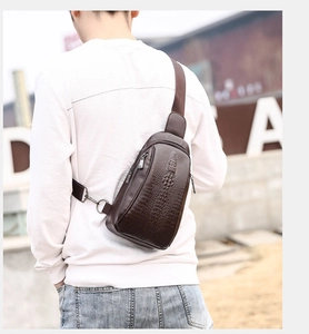 Outdoor shot of men's dark brown crocodile pattern chest bag with metal zipper