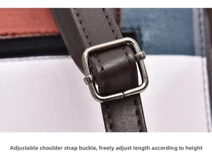 Detail of adjustable dark brown leather strap with vintage silver metal buckle on bag