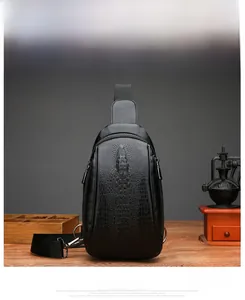 Detail of black embossed crocodile pattern on high-quality leather chest bag for men