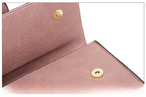 Detail of pink lychee leather handbag with magnetic snap closure and precise stitching