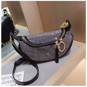 Detail view of crescent rhinestone shoulder bag with silver crystals and gold hardware