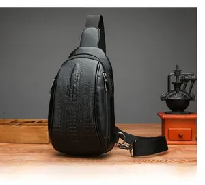 Close-up of crocodile texture leather on black men chest bag with adjustable nylon strap