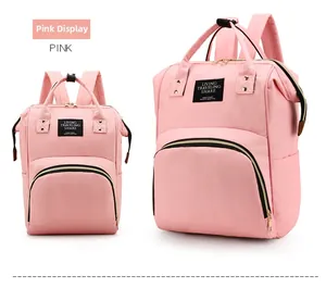 Front view of pink Oxford cloth diaper backpack showing dual handles and side pockets