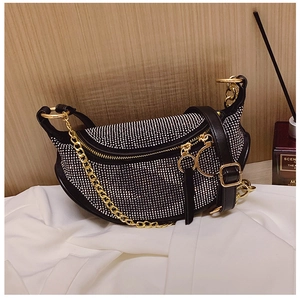 Close-up of crescent rhinestone crossbody bag with gold chain and silver crystal detail