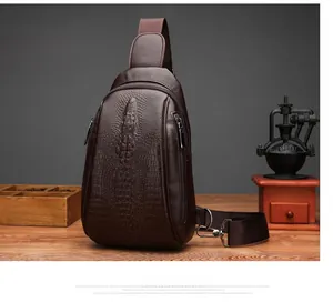 Detail view of dark brown crocodile texture on men's crossbody chest bag with zippers