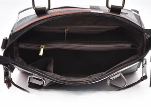 Detail view of the interior compartments and lining of the plaid tote handbag
