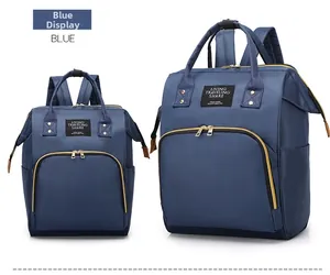 Detail of two sizes of blue nylon backpacks with gold zippers and sturdy dual handles