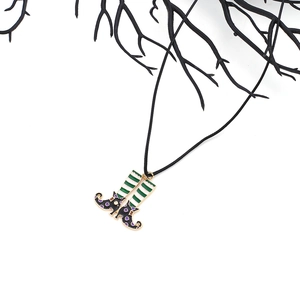 Halloween witch boot pendant necklace with striped socks on black cord and branches