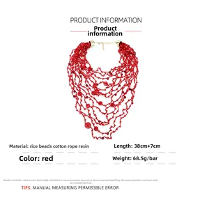 Close-up of bohemian multi-layered coral red beaded necklace with resin accents
