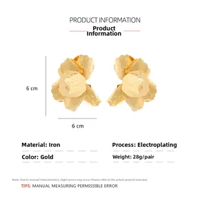 Detailed view of large 6x6cm gold metal flower earrings with product specifications