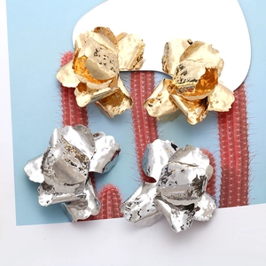 Detail of vintage 3D metallic flower earrings in gold and silver finishes