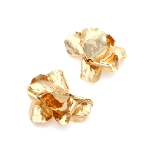 Macro detail of vintage gold 3D flower earrings with textured hammered metal petals