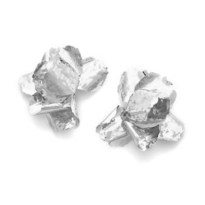 Detailed close-up of sculpted silver floral earrings with 3D textured metallic petals