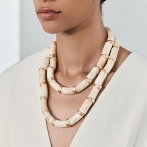 Close-up of double-layer beaded resin necklace with marble texture and gold accents