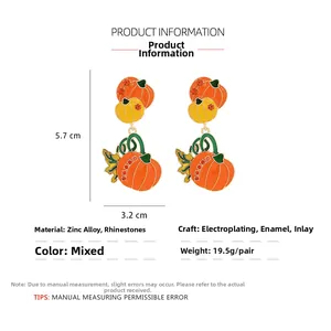 Detail view of pumpkin earrings with zinc alloy, rhinestones and colorful oil drip finish