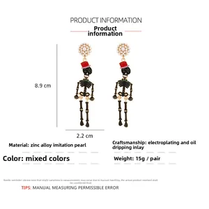 Detail view of funny Halloween skull earrings with dimensions showing 8.9cm by 2.2cm size