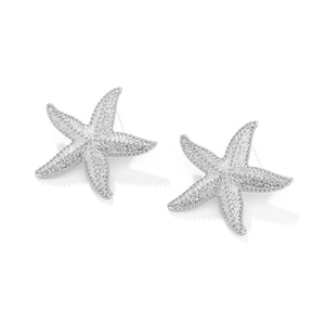 Macro shot of silver starfish stud earrings with detailed granular metallic texture