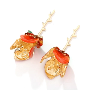Detail of red enamel rose earrings with gold metal stems and vibrant floral petals