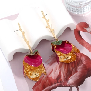 Detail of rose gold tiered flower drop earrings with enamel petals and leaf accents