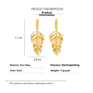 Detailed view of gold leaf earrings showing 7.1cm x 2.8cm dimensions and vein texture