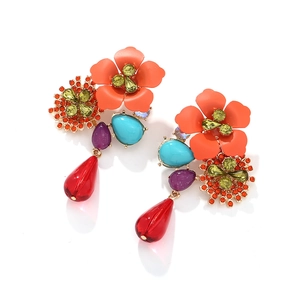 Detail of colorful tiered flower earrings with teardrop beads and sparkling rhinestones
