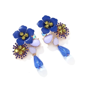 Detail of bohemian layered blue flower earrings with purple gems and teardrop crystals