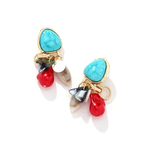 Detail of vintage turquoise and shell tassel earrings with colorful geometric pendants