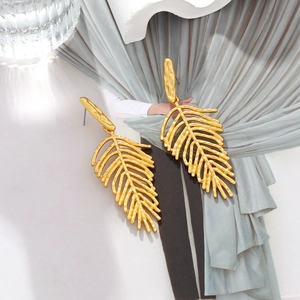 Chic long gold leaf drop earrings with hammered metal texture for a stylish look