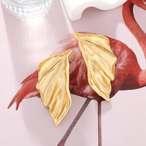 Golden large leaf earrings with detailed vein texture in a tropical bohemian style