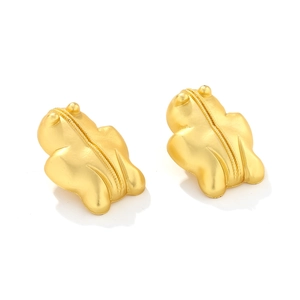 Macro detail of vintage 3D frog stud earrings in matte gold finish and textured back
