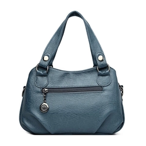 Retro deep blue leather tote bag with front zipper pocket and metal logo pendant charm