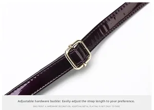 Macro detail of deep purple patent leather strap with adjustable gold buckle hardware