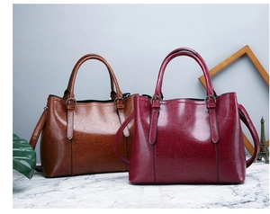 Brown and burgundy patent leather tote bags with glossy finish and dual handles