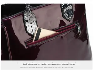 Detail of burgundy crocodile pattern handbag showing functional back zipper pocket for phone