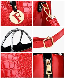 Detail view of red crocodile embossed handbag with snake print handle and gold hardware