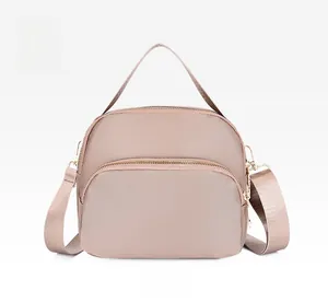 Detailed front view of khaki waterproof oxford fabric crossbody bag with multi-zipper layers