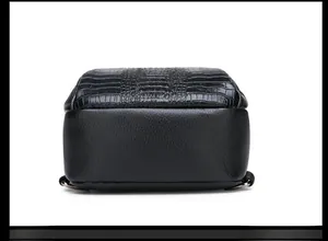 Close-up of black crocodile pattern and litchi grain texture on men's crossbody chest bag