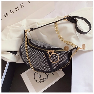 Detail of rhinestone crossbody bag with gold round zipper pull and chain strap