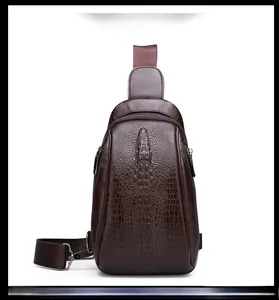 Detail of men's brown crossbody chest bag with embossed crocodile leather texture and zipper
