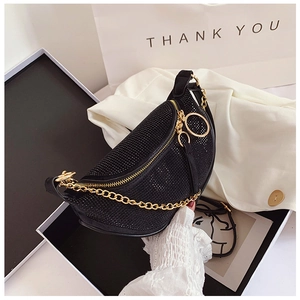 Detail of black rhinestone crescent bag with gold chain and large zipper puller