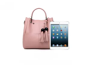 Pink lychee grain faux leather handbag with tassel charm and iPad for size scale