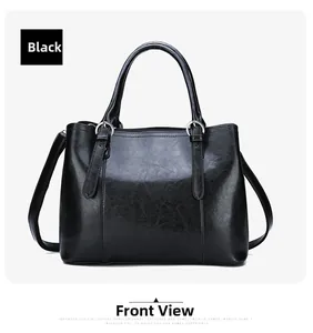 Detailed view of black patent leather handbag featuring glossy texture and silver buckles