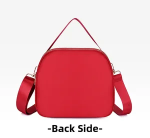 Rear view of vibrant red waterproof oxford fabric shoulder bag with gold zipper and handle