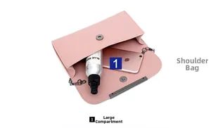 Internal view of pink shoulder bag showing a large compartment and metal chain strap