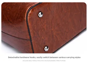 Detail of vintage brown leather bag showing metal feet and precise stitching quality