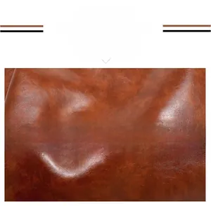 Macro detail of high-quality brown oil wax leather with rich texture and subtle glossy finish