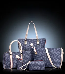 Detailed view of 6-piece navy handbag set with fishhook pattern and beige handles